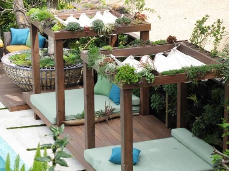 Timber cube shade structure with roman blind covering
