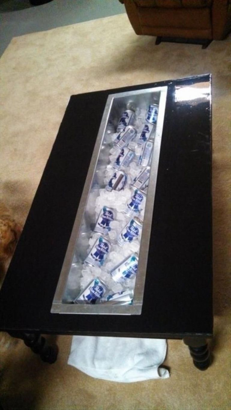 A coffee table with an ice section for cooling beer in your man cave