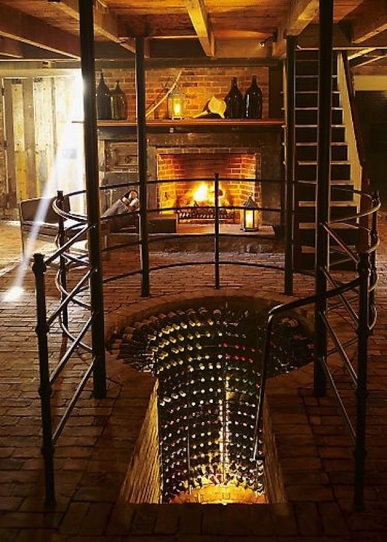 Keyhole shaped wine cellar below living area with fire